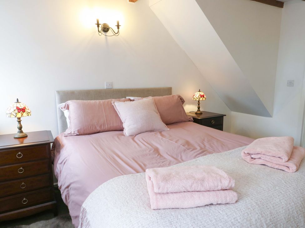 A bedroom with a bed and bedside lamps at Ael Y Bryn Menai Bridge