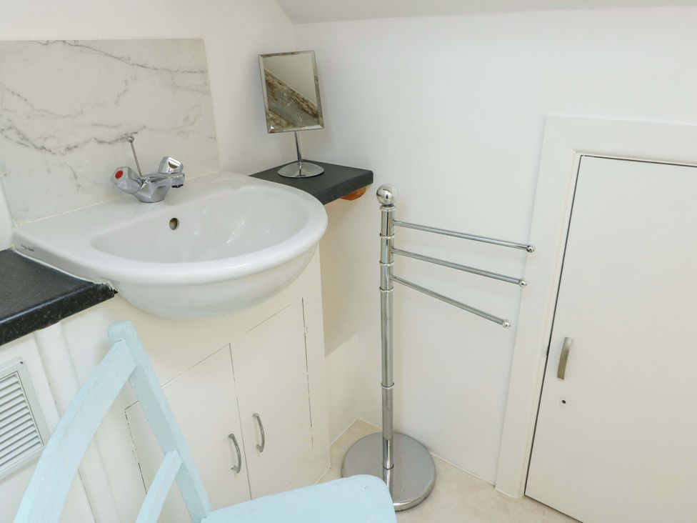A bathroom with a sink and mirror at Ael Y Bryn Menai Bridge