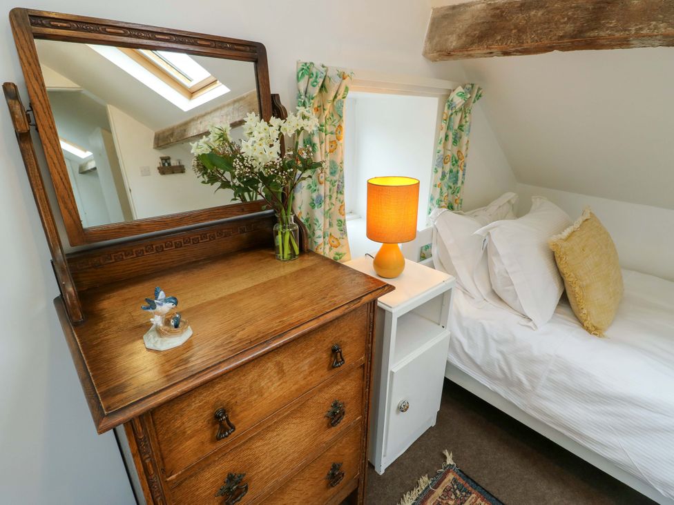 A bedroom with a mirror and chest of drawers at Ael Y Bryn Menai Bridge
