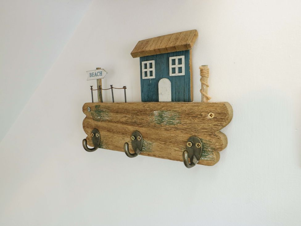 A hook rack with a beach house design and hooks at Ael Y Bryn Menai Bridge