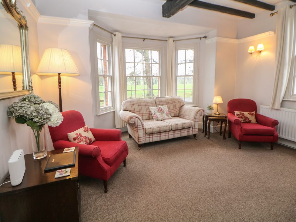 A living room with a sofa and armchairs at South Lodge - Longford Hall Farm Holiday Cottages in Longford near Ashbourne