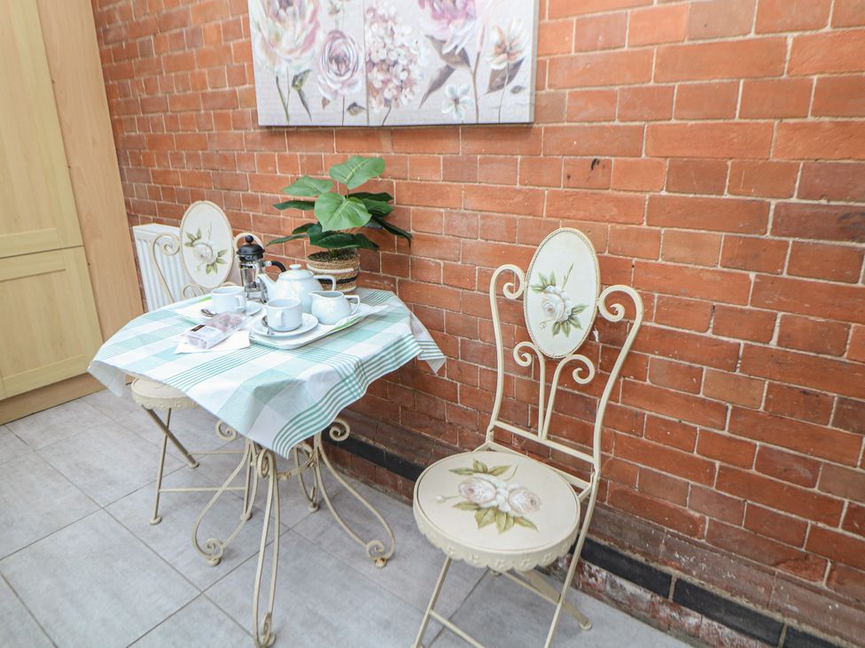 A dining room with a table and chairs at South Lodge - Longford Hall Farm Holiday Cottages Longford near Ashbourne