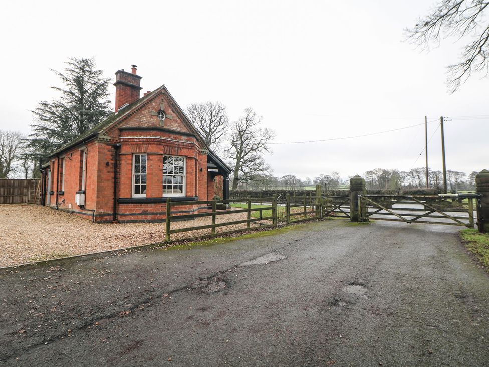A house with a gate and pathway at South Lodge - Longford Hall Farm Holiday Cottages Longford near Ashbourne