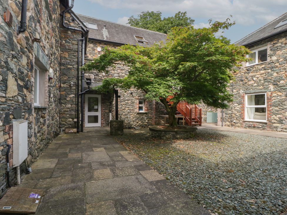 An outdoor area with stone building and a tree at High Spy in Keswick