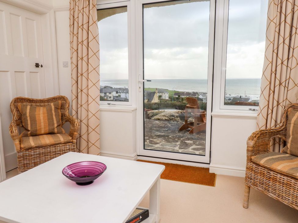 A living room with chairs and a table at Bryn Deryn in Criccieth