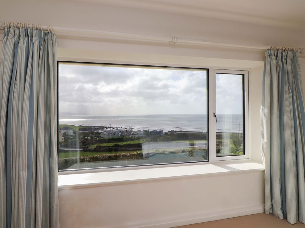 A room with a window showing a sea view at Bryn Deryn in Criccieth