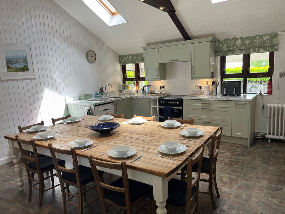 A kitchen with a table and chairs at Bryn Eira Stables in Llanfair PG