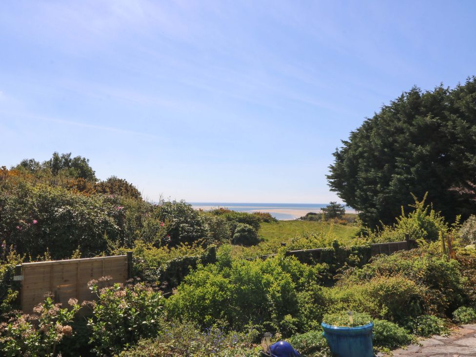A view of ocean and greenery from the garden at Bryn Y Mor, Borth Y Gest