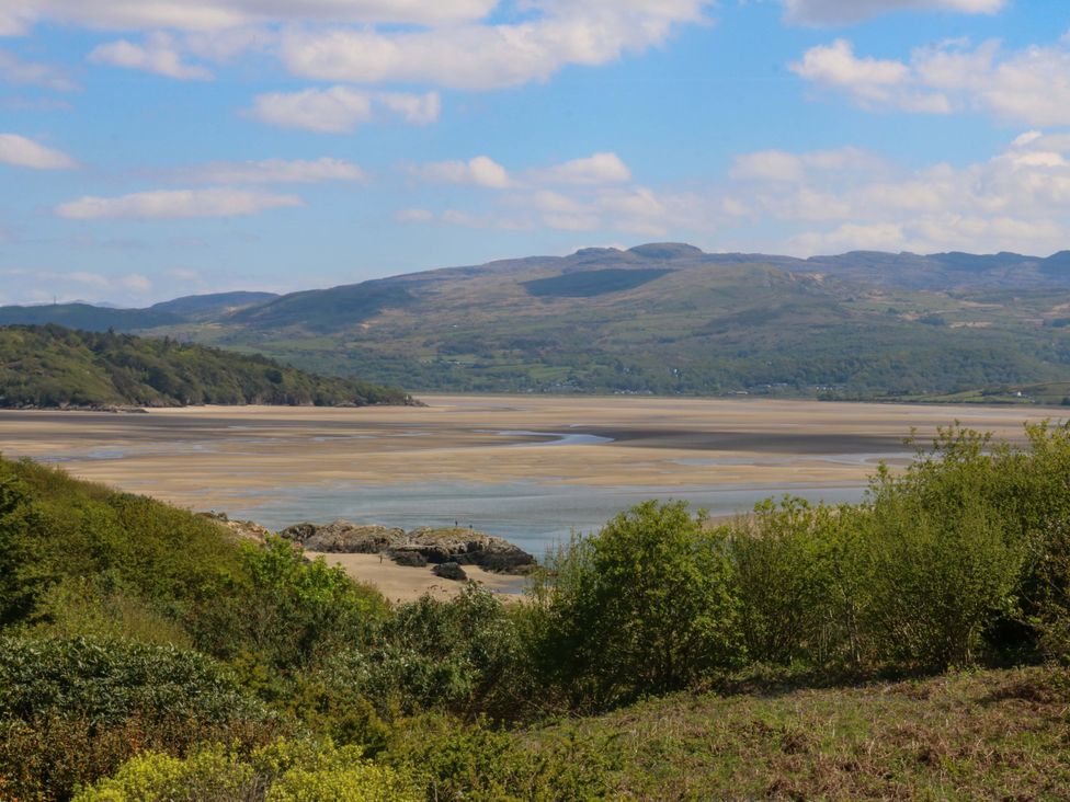A view of a river, mountains and vegetation at Bryn Y Mor,  Borth Y Gest