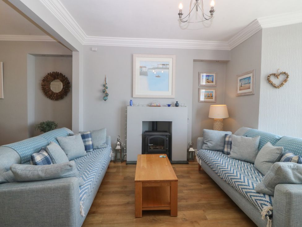 A living room with sofas and a coffee table at Captain's Rest in Criccieth