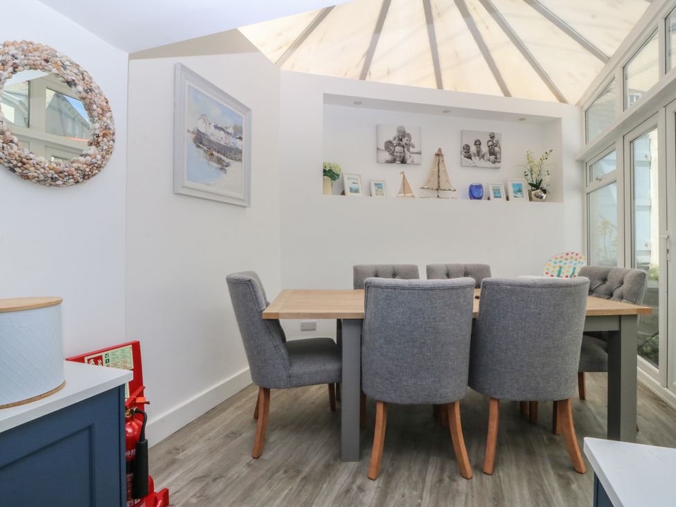 A dining room with a table and chairs at Captain's Rest in Criccieth