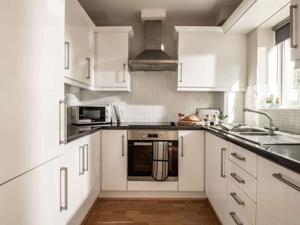 A kitchen with cabinets and appliances at Coed y Felin in Conwy