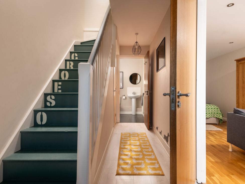 A hallway with stairs and a bathroom at Coed y Felin in Conwy