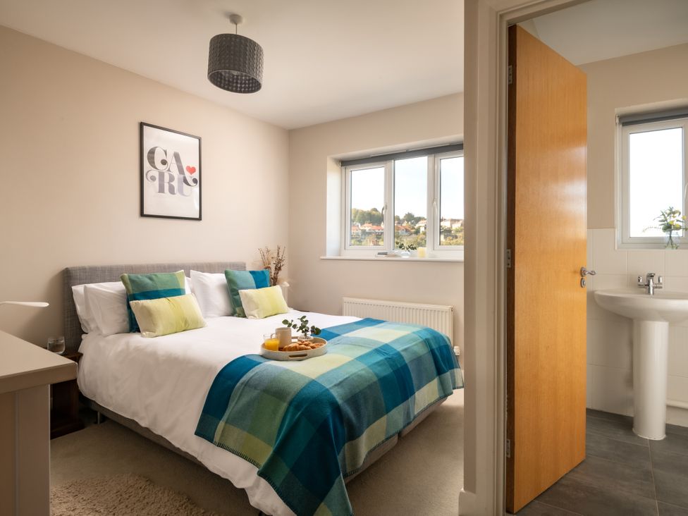 A bedroom with a bed and window at Coed y Felin in Conwy