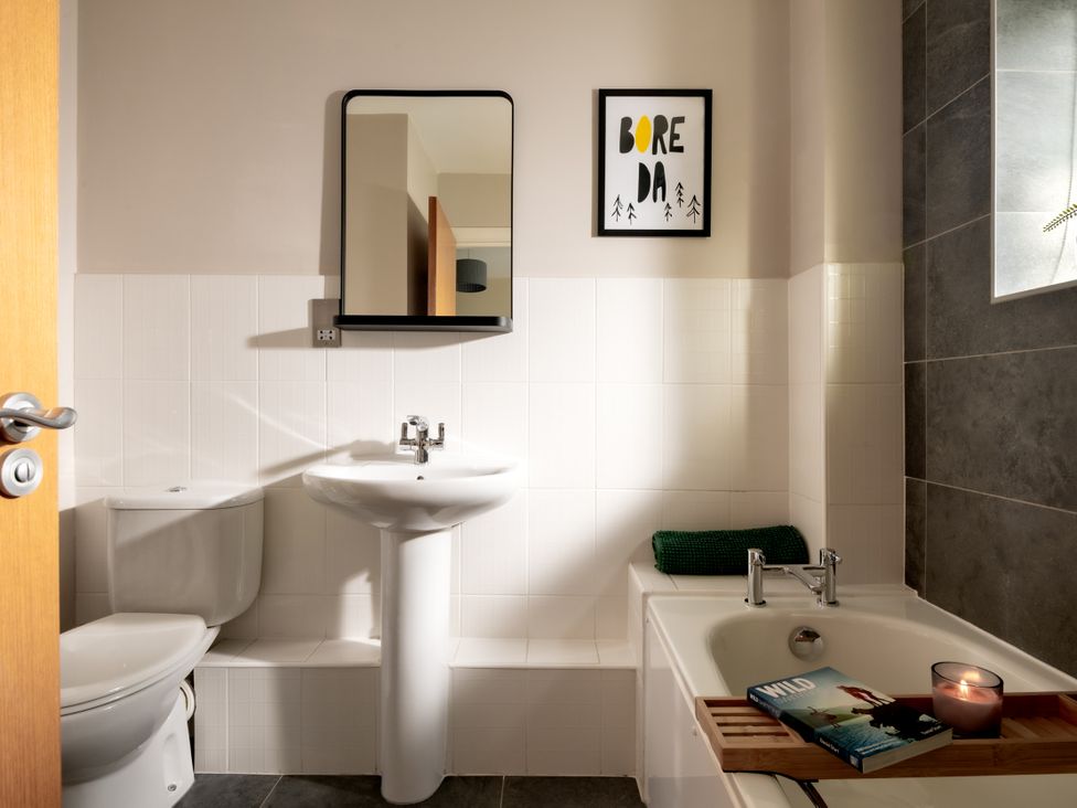 A bathroom with a sink, toilet, and bathtub at Coed y Felin in Conwy