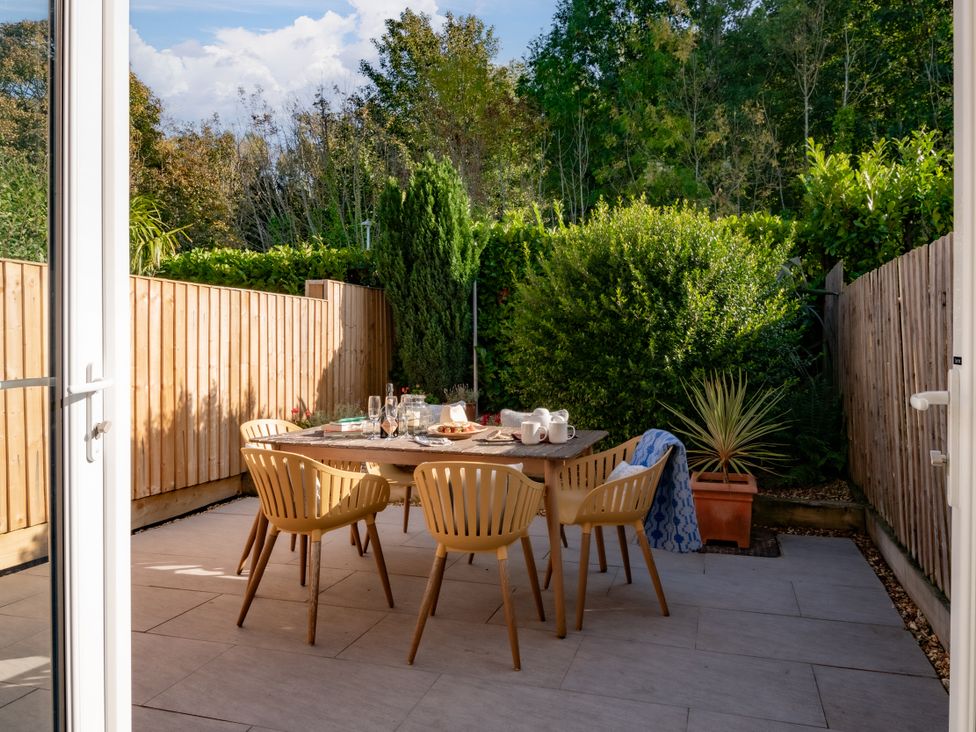 An outdoor dining area with a table and chairs at Coed y Felin in Conwy