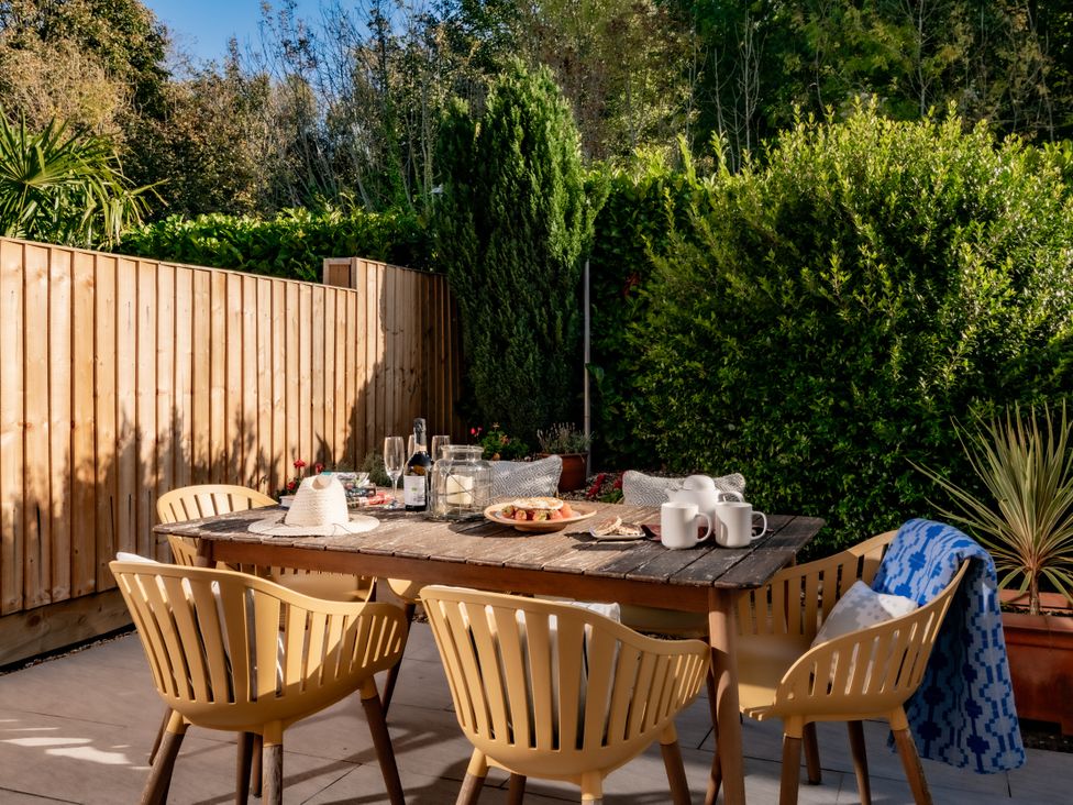 A dining area with a table and chairs at Coed y Felin, Conwy