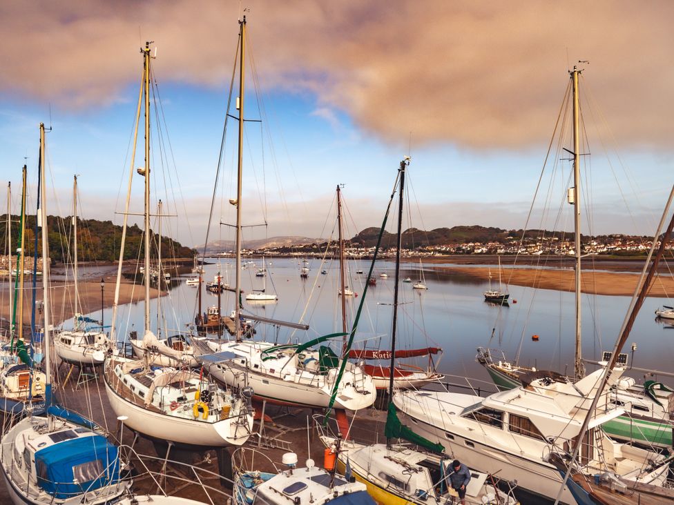A marina with sailboats on the water at Coed y Felin Conwy