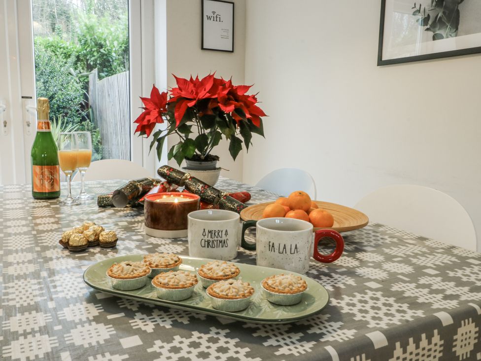 A dining room table with holiday decorations at Coed y Felin in Conwy