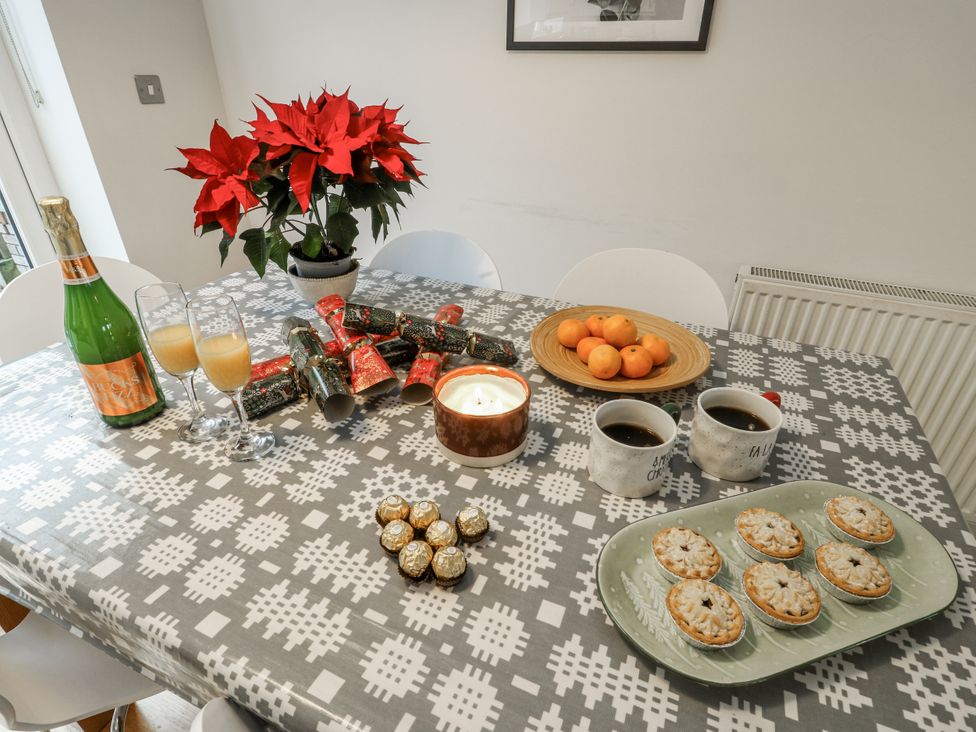 A dining room with a table set for celebration at Coed y Felin in Conwy