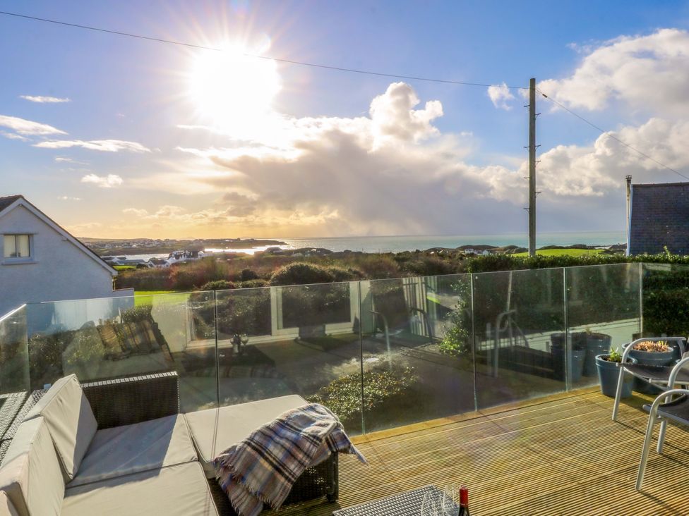 An outdoor area with furniture and view of the ocean at Curragho in Trearddur Bay