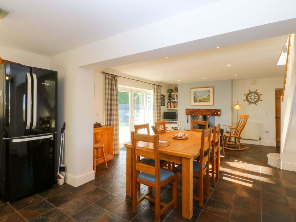 A kitchen with dining area at Curragho in Trearddur Bay
