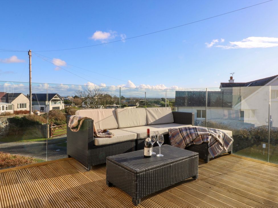 An outdoor seating area with a sofa and coffee table at Curragho in Trearddur Bay