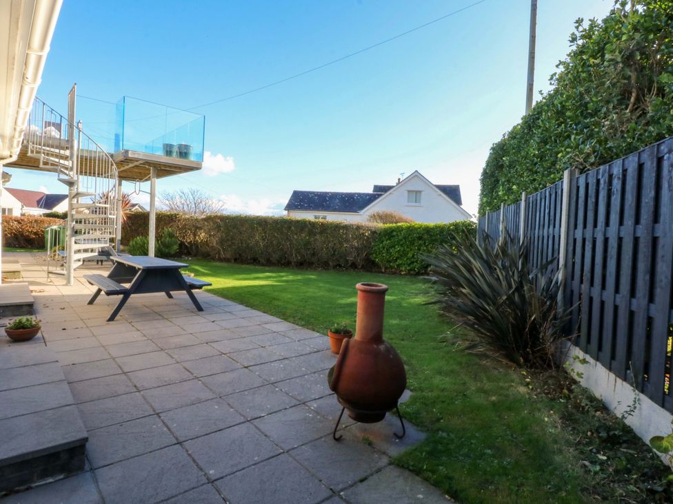 A garden with a staircase and table at Curragho in Trearddur Bay