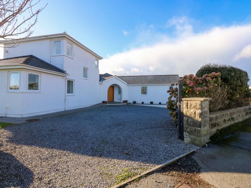 A house exterior with a gravel driveway and entrance at Curragho in Trearddur Bay