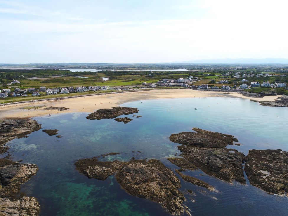A beach with rocks and water at Curragho in Trearddur Bay
