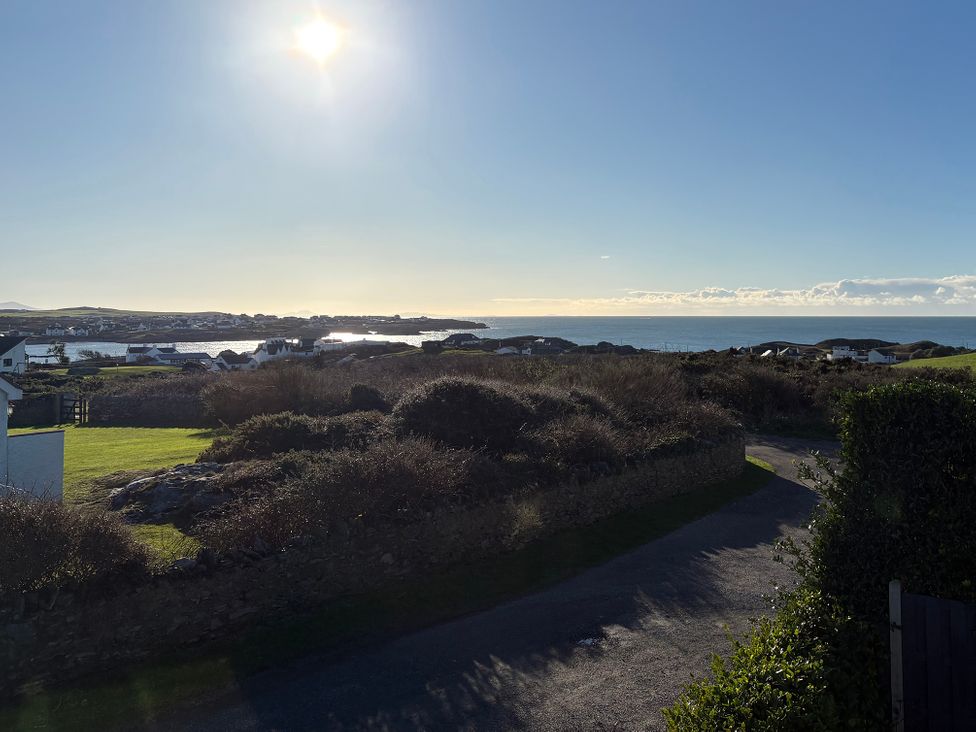 A scenic view of the ocean and houses at Curragho in Trearddur Bay