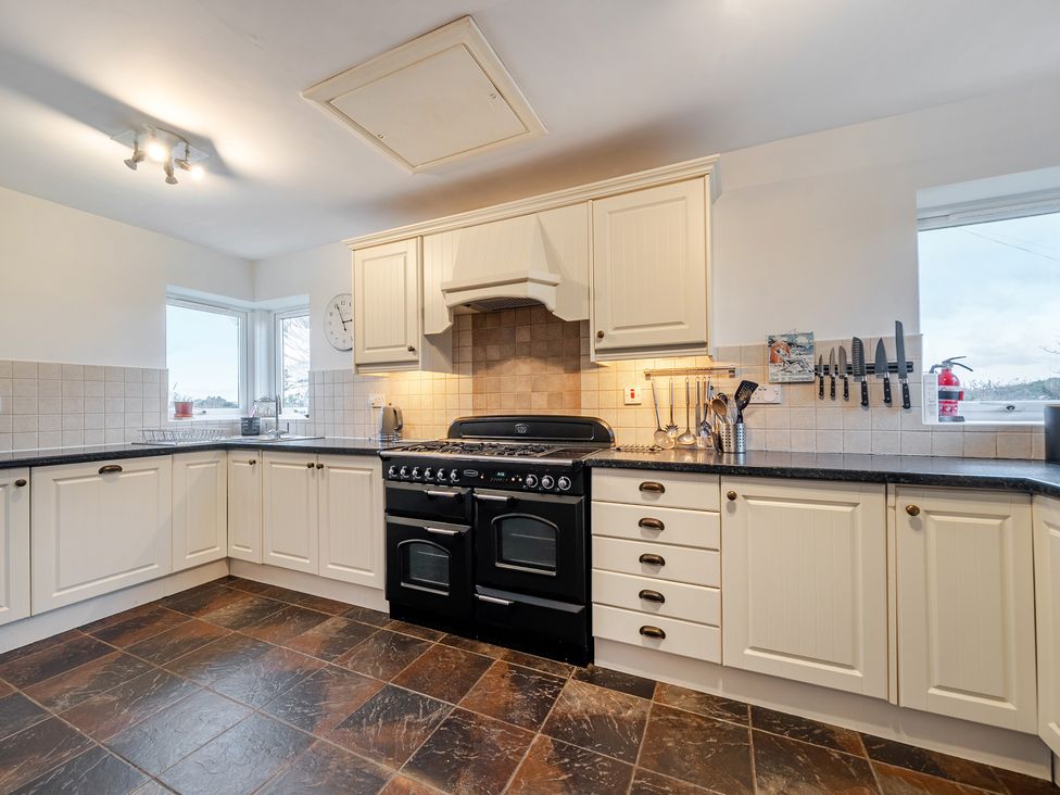 A kitchen with an oven and cabinets at Curragho in Trearddur Bay