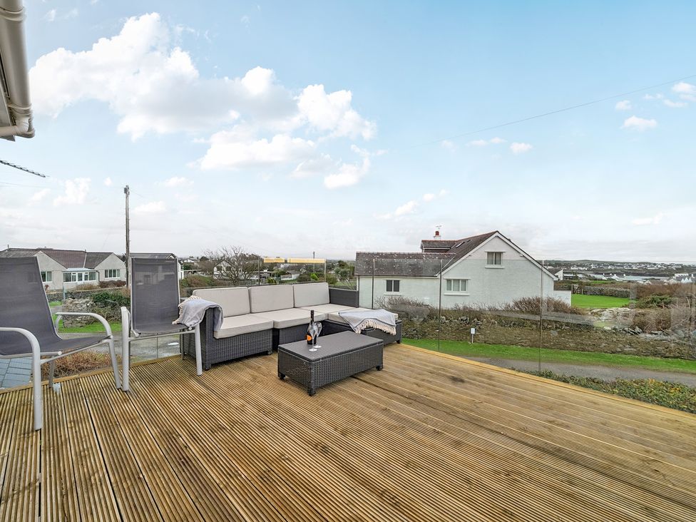 An outdoor seating area with a sofa and coffee table at Curragho in Trearddur Bay