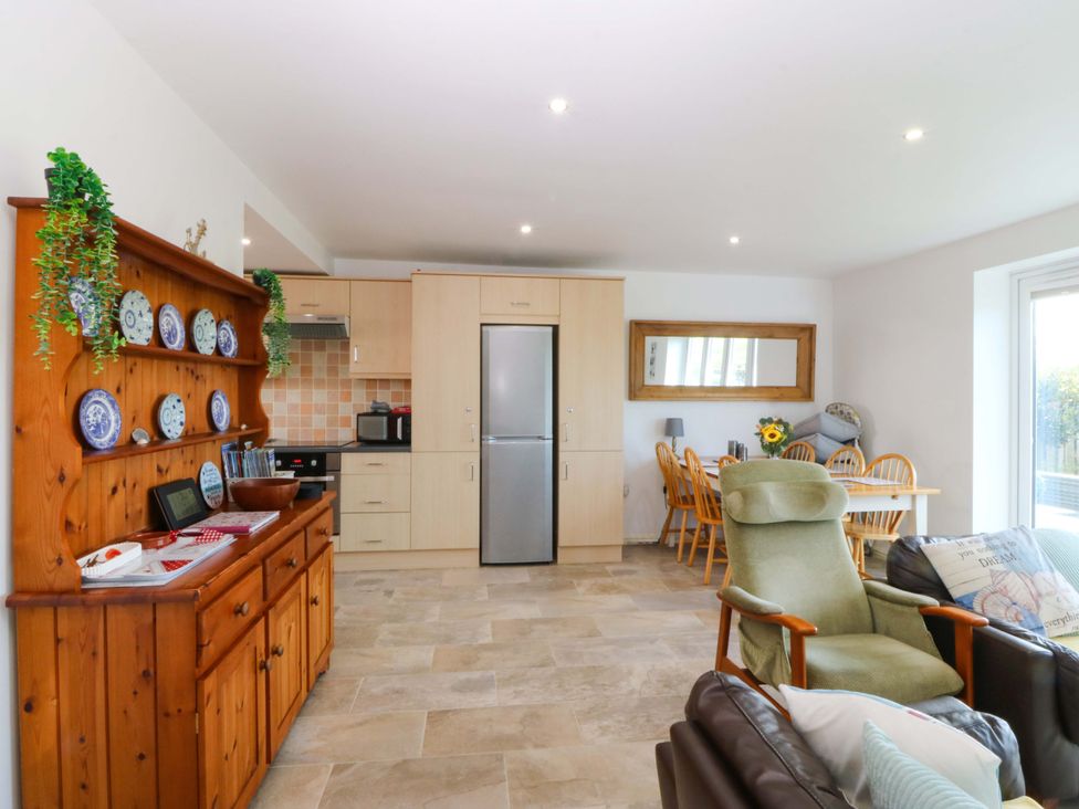 A kitchen with dining area at Farm Cottage in Cemaes Bay