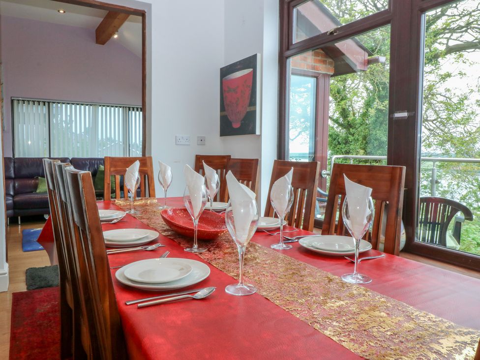 A dining room with a table set for dinner at Gwylan Uchaf Y Felinheli