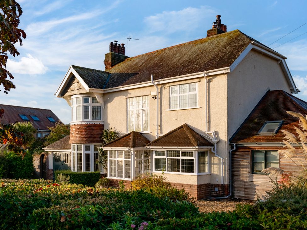 A house with multiple windows and greenery at Summerfield in Deganwy