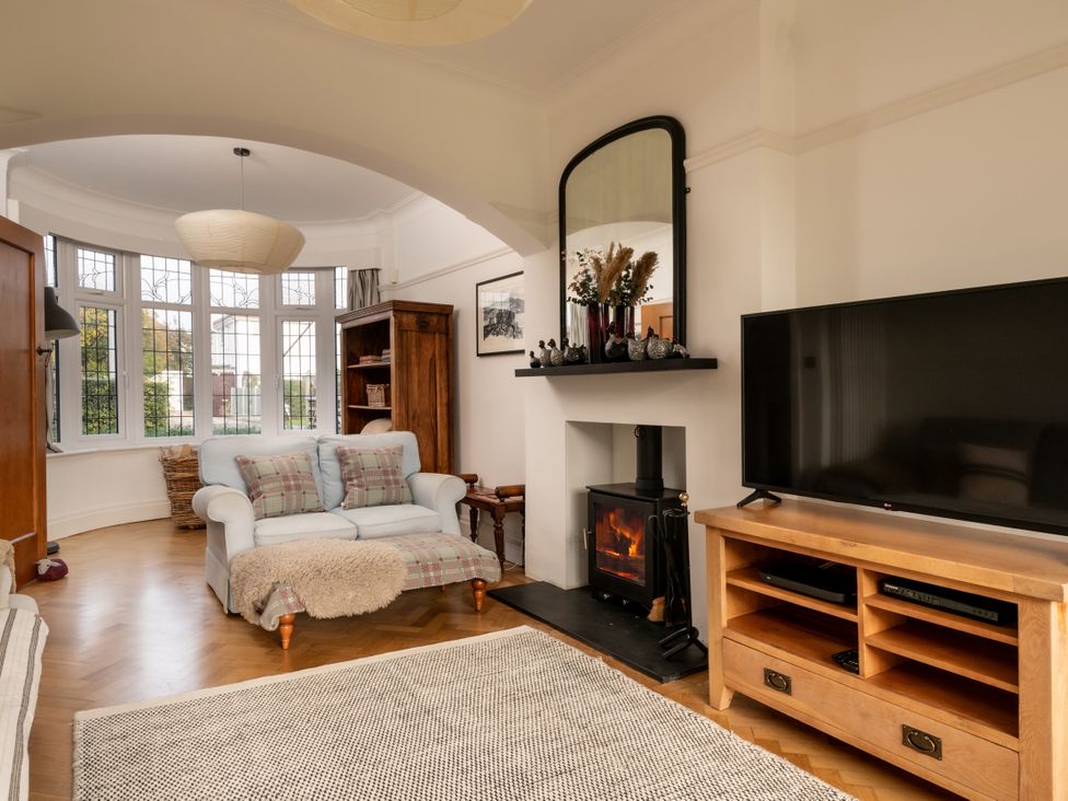 A living room with a sofa and fireplace at Summerfield in Deganwy