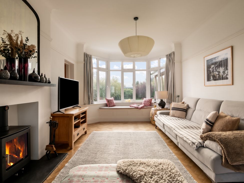 A living room with a sofa and television at Summerfield in Deganwy