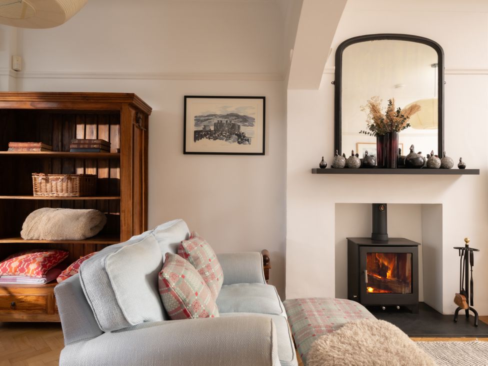 A living room with a sofa and fireplace at Summerfield in Deganwy