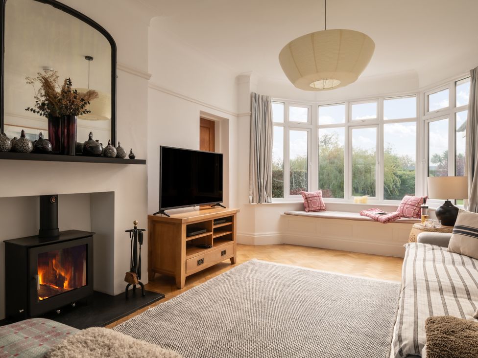A living room with a fireplace and tv at Summerfield in Deganwy