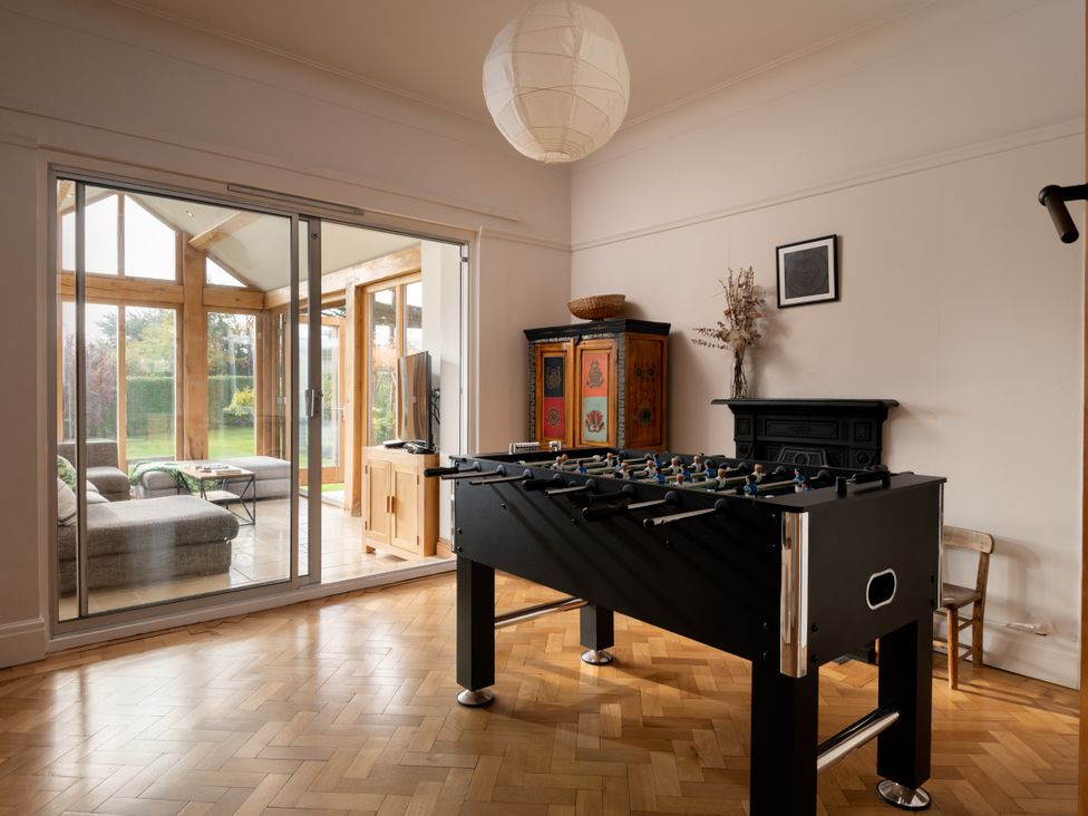 A game room with a foosball table and sliding doors at Summerfield in Deganwy