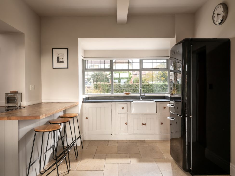 A kitchen with a sink and refrigerator at Summerfield in Deganwy