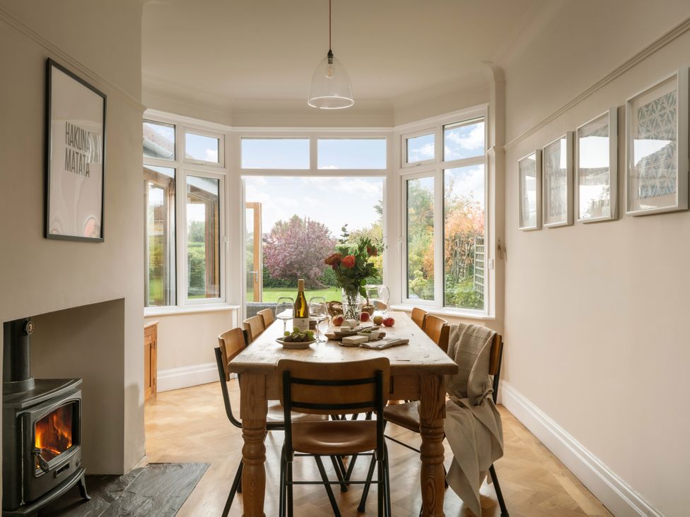 A dining room with a table set for a meal at Summerfield in Deganwy