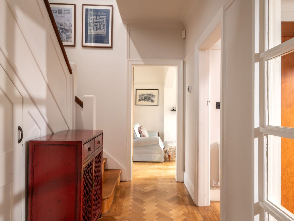 A hallway with staircase and console table at Summerfield in Deganwy
