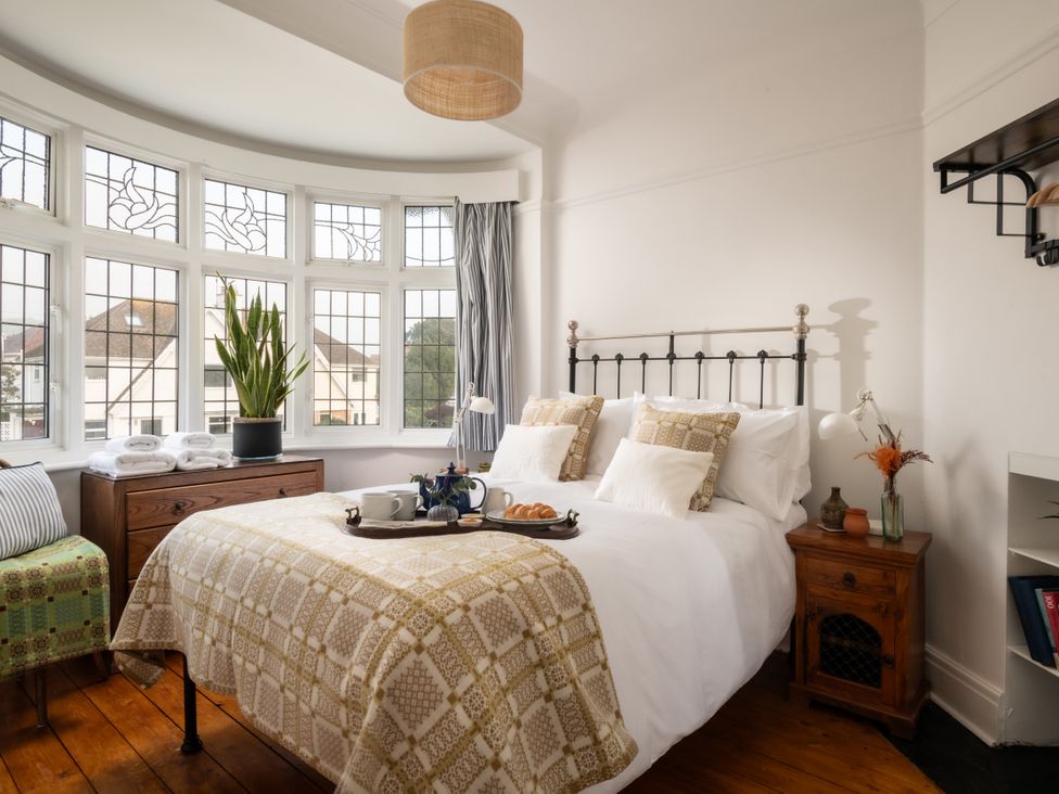 A bedroom with a bed and breakfast tray at Summerfield in Deganwy