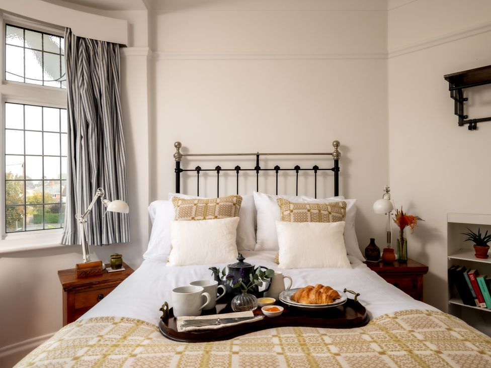 A bedroom with a bed and breakfast tray at Summerfield in Deganwy