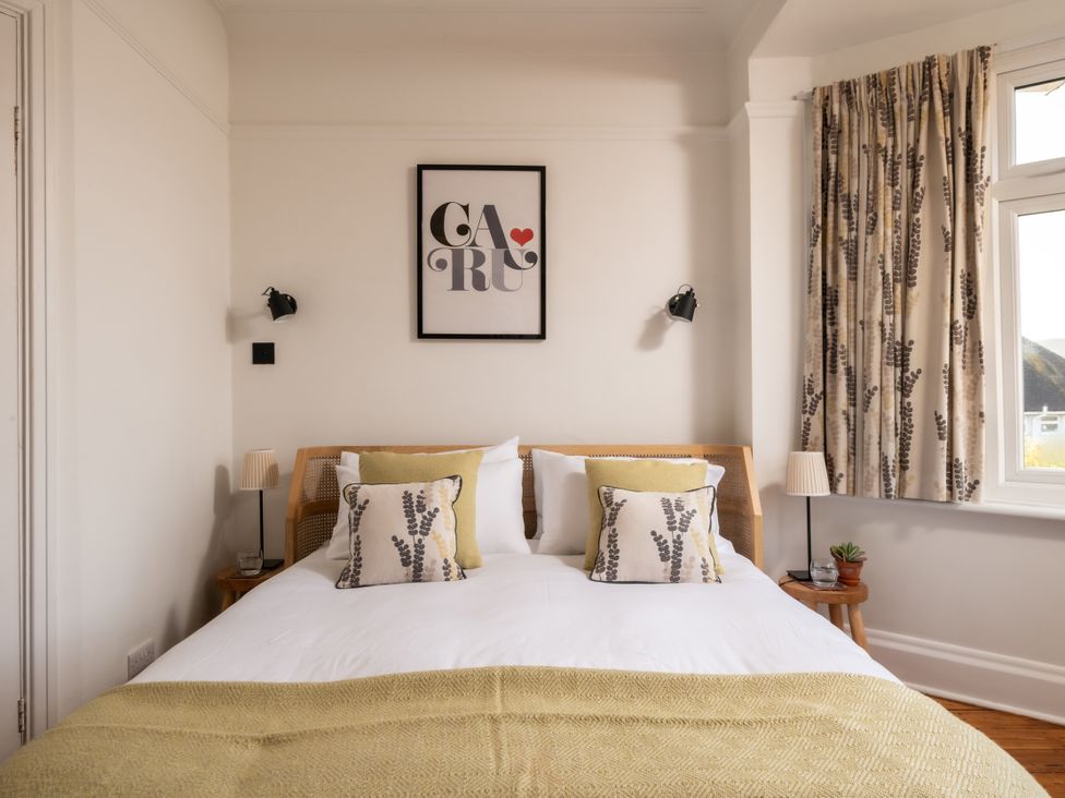 A bedroom with a bed and artwork at Summerfield in Deganwy