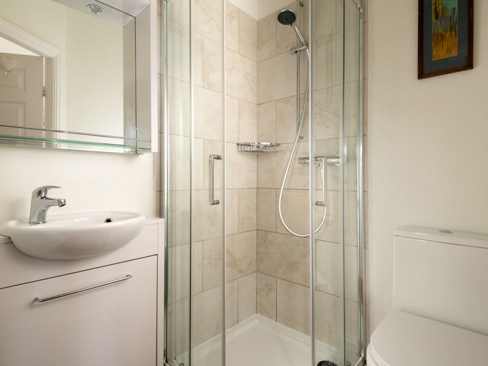 A bathroom with a shower and wash basin at Summerfield in Deganwy