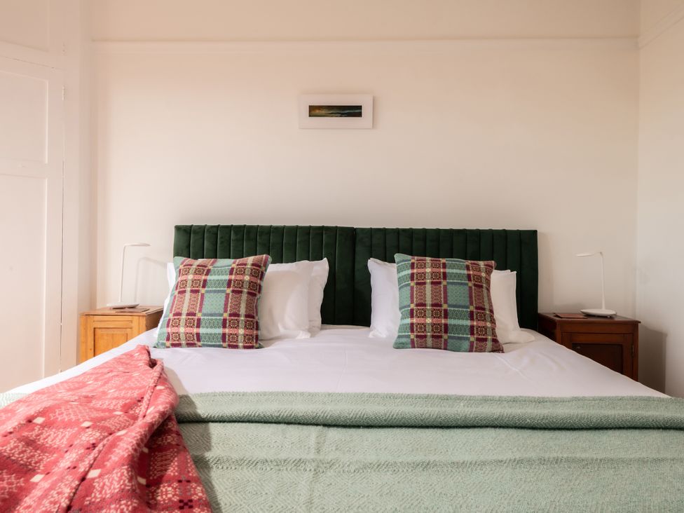 A bedroom with a bed and pillows at Summerfield in Deganwy