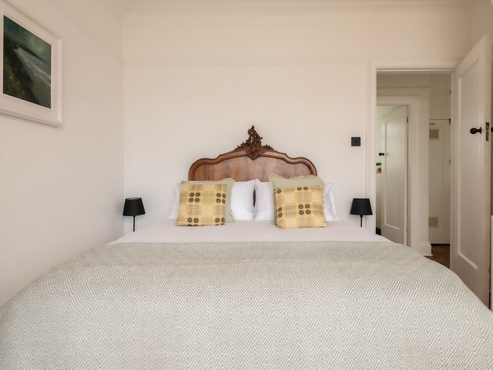 A bedroom with a bed and artwork at Summerfield in Deganwy